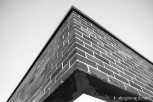 brick cantilever black and white photo